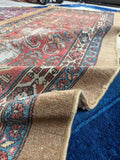 Folded view showing flexibility and wear of the Persian runner.