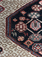 Persian runner with animal motifs on moody ground.
