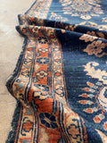 Antique rug low-pile texture shot angled to show the smooth, durable surface and weave.