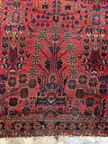 Close view of antique Sarouk rug border showing traditional Persian floral detailing.