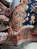 Corner view  of oversize Persian Sarouk rug with substantial weight and refined design.