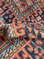 Scatter-size Persian Gharajeh Heriz rug with handwoven vegetable-dyed wool, symbolic motifs, and subtle age-related wear.