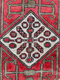 Close up of handwoven medallion in an early 1900s Serab rug.