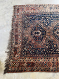 One end of rug showing the main  field with small floral and geometric elements.