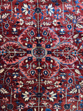 Persian Tabriz rug with central medallion and angular botanical motifs.