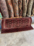 Handwoven Persian Yomut front panel showing intricate geometric patterns and vintage nomadic craftsmanship.