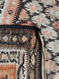 Underside view of antique decorative flat weave runner with soft and vivid contrasts.