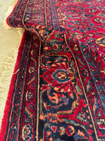 Richly colored Lilihan rug with flexible, weighted handle.