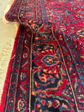 Richly colored Lilihan rug with flexible, weighted handle.