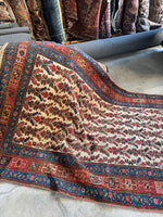 Handwoven Persian rug with bold natural dye colors.