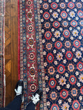 Antique Persian rug border featuring stylized turtle and floral motifs.