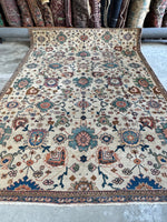 Decorative Persian rug with intricate floral patterns and paisley accents.