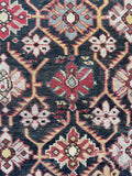 Close up view of nomadic woven Caucasian rug from the early 20th century.