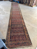Long and narrow antique Persian runner.