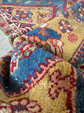 Antique Persian floor rug with traditional pole medallions filled with floral and tribal symbols.
