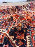Hand Knotted Antique Persian Heriz Rug featuring geometric tribal patterns, vegetable-dyed wool, scattered age-related wear, and sturdy construction.