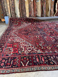 Vintage Persian Heriz area rug. Large tribal wool carpet with floral borders, bold medallion, and durable hand-knotted construction.
