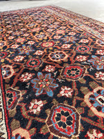 Close-up of floral motif showing natural dye color variation in outlines