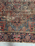 Close-up view of vintage Persian rug with worn character and mellowed vegetable dyes.