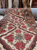 Antique Persian runner rug with a dark espresso brown and walnut floral chain border.