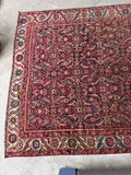 Antique Karabagh rug end laying flat