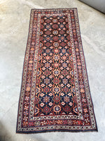 Full layout of handwoven Persian rug showing all-over floral motif