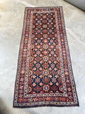 Full layout of handwoven Persian rug showing all-over floral motif