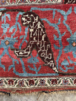 Rug edge with visible wear and fading in natural dyes.
