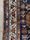 Border band view of vegetable dyed Persian Shiraz rug with soft patina and collected character.