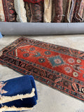 Early 1900s hand-knotted Caucasian runner with geometric tribal design for hallway or kitchen.