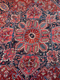 Antique Heriz rug. Red, navy, and ivory Persian area rug with powerful tribal artwork, full pile, and durable hand-knotted construction.