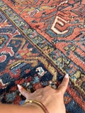 Antique Persian Heriz rug. Hand knotted wool carpet with a square format, warm terracotta tones, and beautifully mellowed antique patina. Some wool loss due to wear.