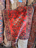Antique Persian Hamadan scatter rug with vibrant floral motifs on a coral field and navy blue border.