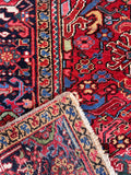 Underside view of a rustic tribal rug from Northwest Persia made of vegetable-dyed wool.