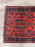 Rustic antique Malayer runner showing traditional floral and geometric border details.