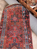 Burnt orange antique Persian runner highlighting the rich vegetable-dyed wool and heavy, durable handle.