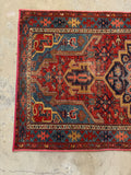 Antique geometric Persian rug. Hand knotted 1920s Heriz carpet with bold architectural design, animal motifs, and rich brick red and blue colors.