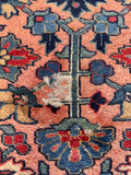 Rare salmon color Heriz rug detail showcasing natural vegetable dye abrash, tonal variations, and some scattered wear.