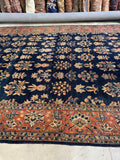 Mohajeran Sarouk rug with deep navy field and crisp floral drawing.