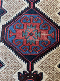 Vibrant vegetable dyed wool showcased in a medallion with tribal motifs.