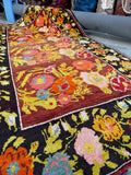 Close up view of vintage Karabagh 5x9 rug in excellent condition with lively floral field.