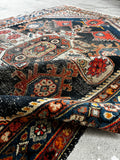 Antique low-pile rug crafted by Kurdish weavers around the 1920s, featuring durable wool construction.
