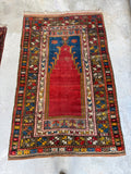 Antique prayer rug featuring vibrant turmeric yellow accents and red mihrab field.