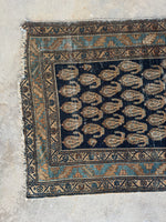 One end view of long Persian runner with a mix of cool and warm earth tones.