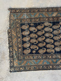 One end view of long Persian runner with a mix of cool and warm earth tones.