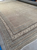 Calm neutral palette vintage rug with multiple border bands.