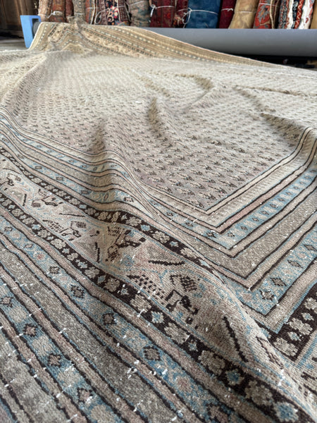 Antique Persian Seraband rug with small paisley motifs and muted blush undertones.