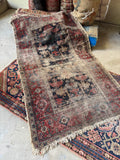 Antique 1890s Persian Malayer rug with distressed navy ground and wide red border.