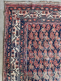 Shabby chic Persian scatter rug with navy field, repeating paisley motifs and authentic antique wear.