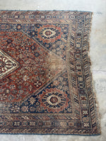 Persian Shiraz rug with diamond medallion and tribal border designs.